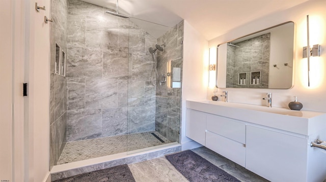 full bath with vanity and tiled shower