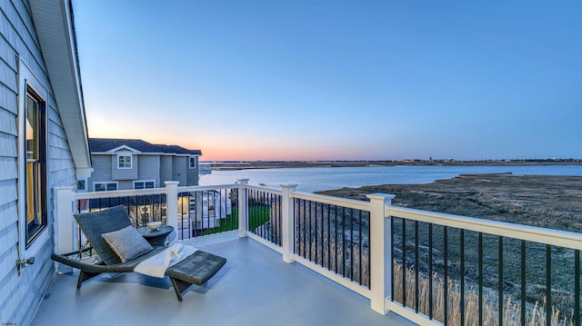balcony at dusk with a water view