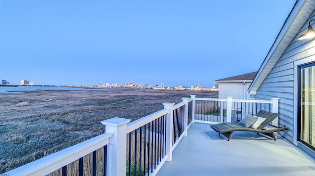 balcony with a view of city and a water view