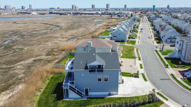 drone / aerial view with a residential view and a water view