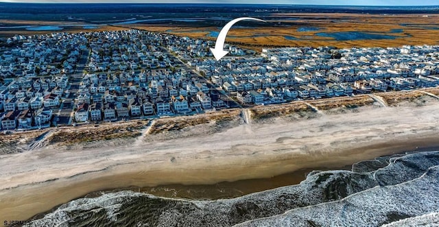 drone / aerial view featuring a residential view and a water view