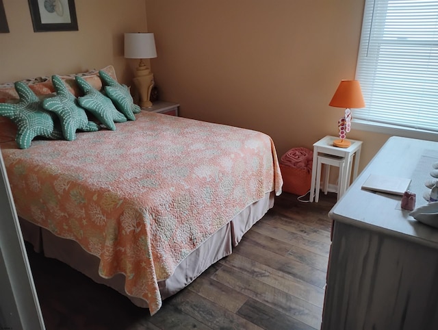 bedroom featuring dark wood finished floors