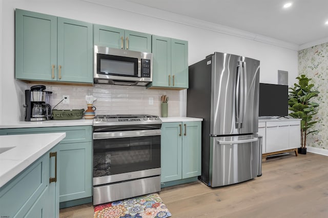 129 Seaside, Atlantic City, NJ 08401 - kitchen featuring light wood-type flooring, crown molding, tasteful backsplash, baseboards, and appliances with stainless steel finishes