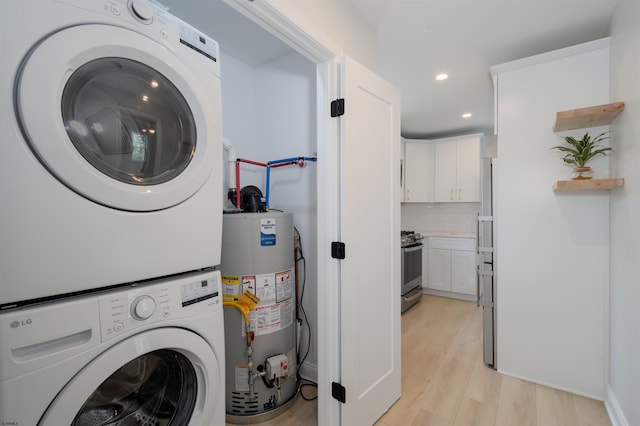 clothes washing area with recessed lighting, stacked washer / drying machine, laundry area, light wood-style floors, and gas water heater