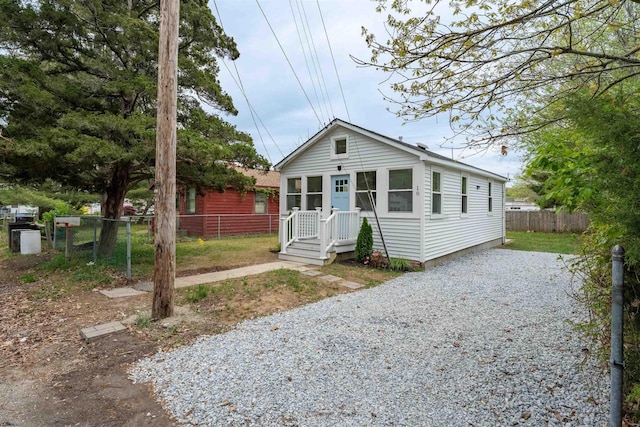 bungalow-style house with fence