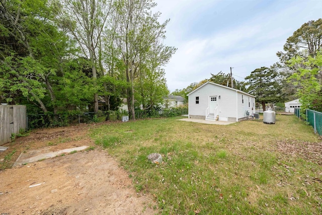 view of yard with entry steps and a fenced backyard
