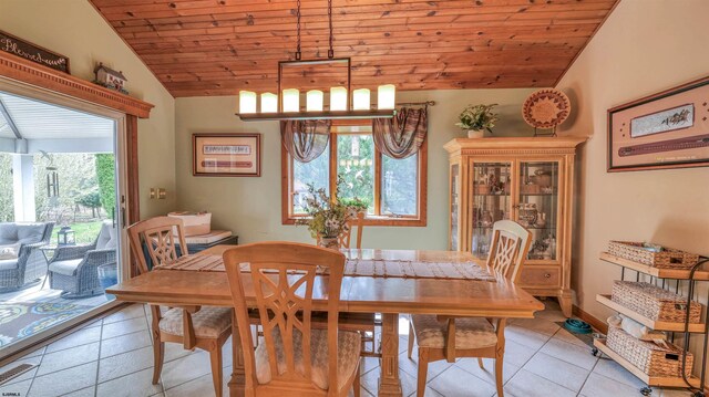 dining room with light tile patterned floors, visible vents, vaulted ceiling, and wooden ceiling