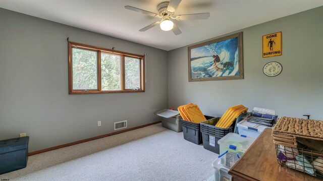interior space with baseboards, visible vents, a ceiling fan, and carpet
