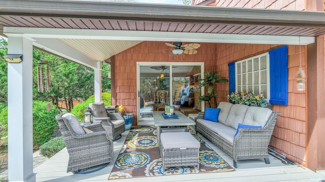 wooden deck with outdoor lounge area and ceiling fan