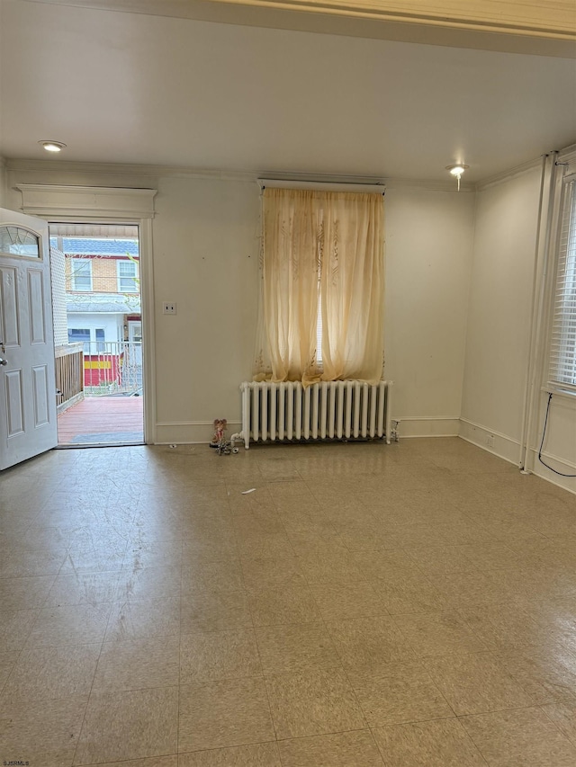 empty room with radiator and baseboards