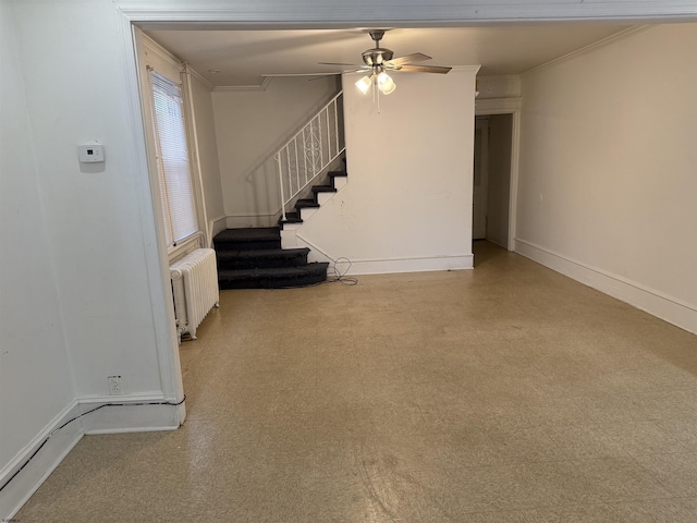 unfurnished living room with radiator, ceiling fan, stairway, and ornamental molding