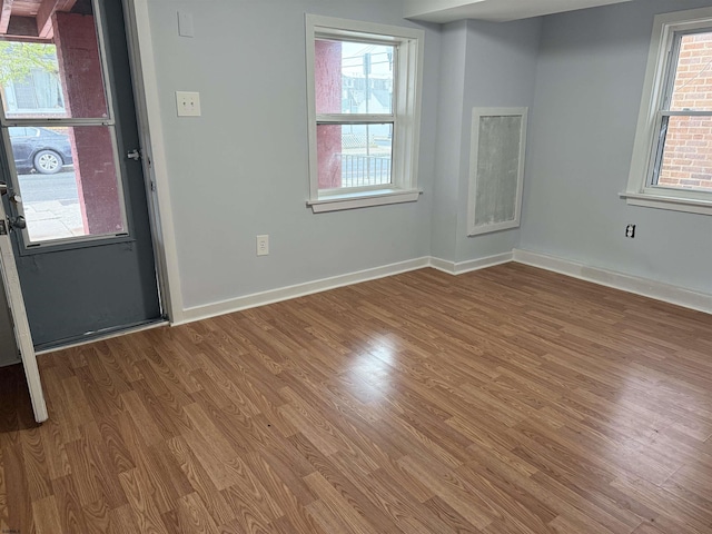 foyer entrance with wood finished floors and baseboards