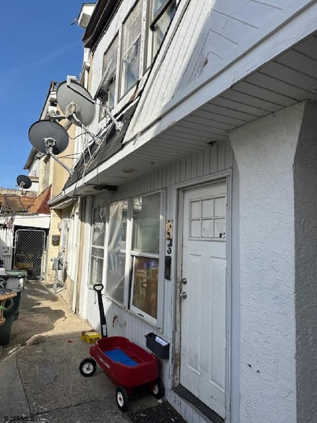 doorway to property with stucco siding