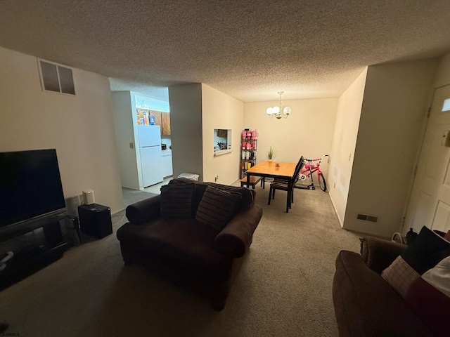 25 Liberty Ct Unit 25, Galloway Township, NJ 08205 - carpeted living room featuring visible vents, a textured ceiling, and a chandelier