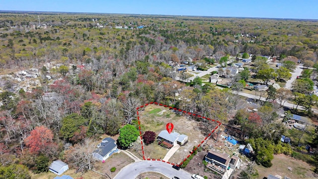 birds eye view of property featuring a view of trees