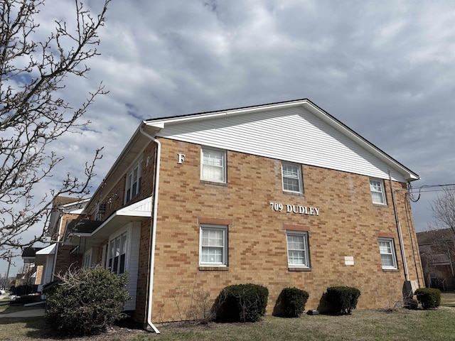 view of home's exterior with brick siding