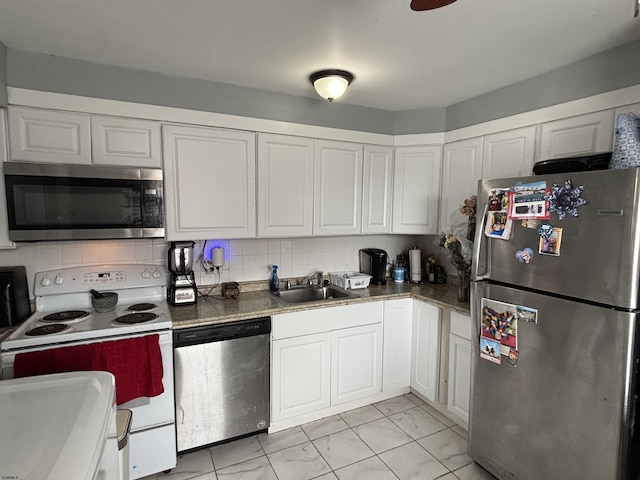 kitchen featuring a sink, marble finish floor, appliances with stainless steel finishes, and white cabinets