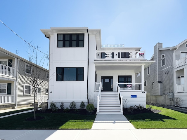 5513 W Ave Fl 1St, Ocean City, NJ 08226 - view of front of home featuring board and batten siding, a porch, and a front lawn