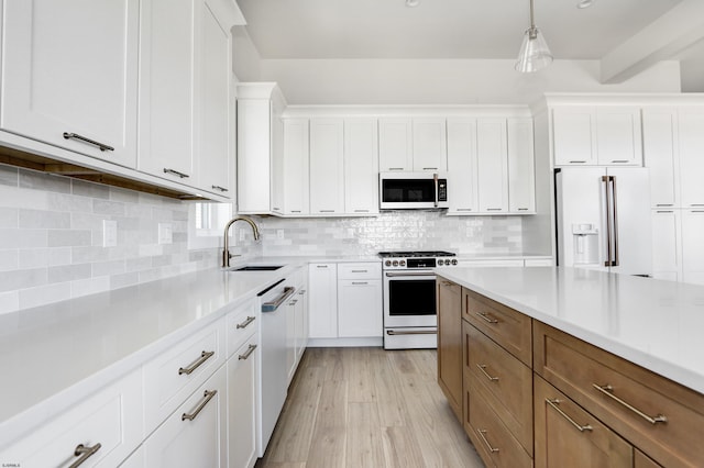 5513 W Ave Fl 1St, Ocean City, NJ 08226 - kitchen featuring white cabinets, a sink, white appliances, light countertops, and backsplash