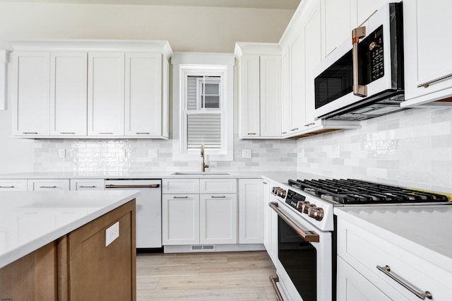 5513 W Ave Fl 1St, Ocean City, NJ 08226 - kitchen featuring white appliances, white cabinets, a sink, and light countertops