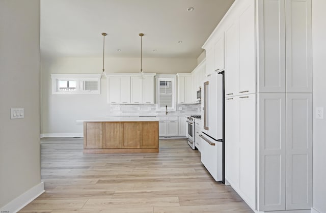 5513 W Ave Fl 1St, Ocean City, NJ 08226 - kitchen with gas range, a sink, baseboards, high end white refrigerator, and light countertops
