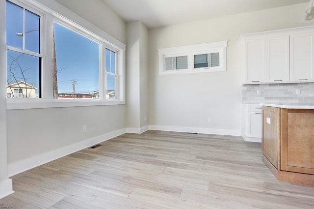 5513 W Ave Fl 1St, Ocean City, NJ 08226 - unfurnished dining area featuring visible vents, light wood finished floors, and baseboards