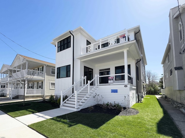 5513 W Ave Fl 1St, Ocean City, NJ 08226 - view of front of property featuring board and batten siding, a balcony, and a front yard