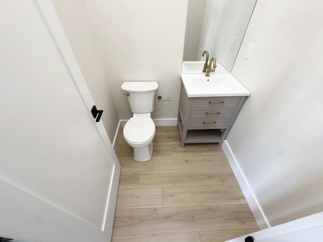 5513 W Ave Fl 1St, Ocean City, NJ 08226 - bathroom featuring baseboards, wood finished floors, toilet, and vanity