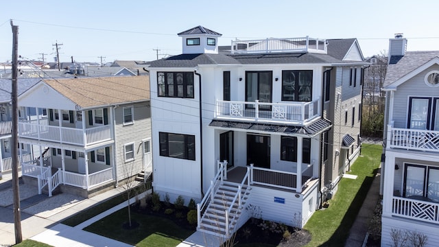 5513 W Ave Fl 1St, Ocean City, NJ 08226 - view of front of home featuring stairs, a shingled roof, and a balcony