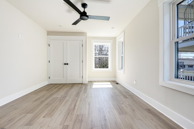5513 W Ave Fl 1St, Ocean City, NJ 08226 - unfurnished bedroom with baseboards, multiple windows, and light wood-style flooring