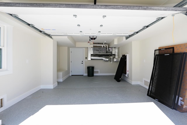 5513 W Ave Fl 1St, Ocean City, NJ 08226 - garage featuring baseboards and a garage door opener