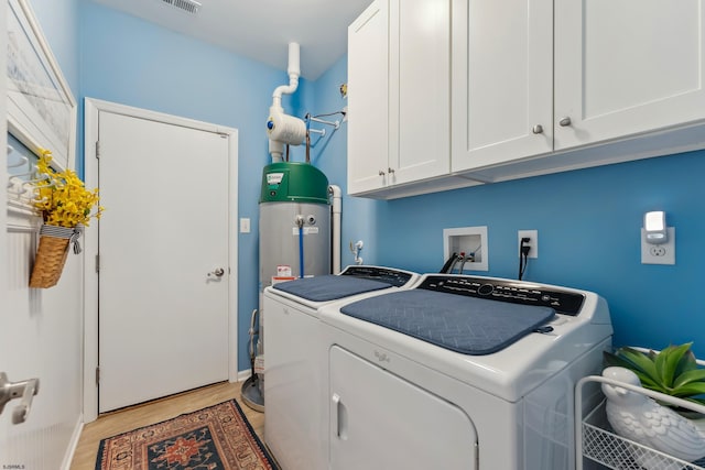 220 Ivy Rd, Egg Harbor Township, NJ 08234 - laundry room with cabinet space, water heater, baseboards, light wood-type flooring, and washer and clothes dryer