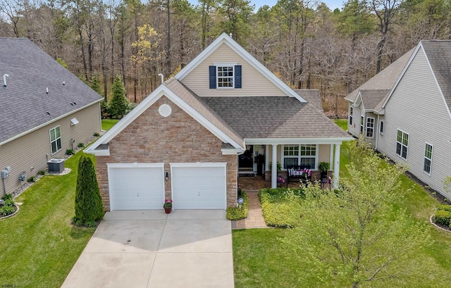 220 Ivy Rd, Egg Harbor Township, NJ 08234 - traditional-style house featuring covered porch, central air condition unit, concrete driveway, a shingled roof, and stone siding