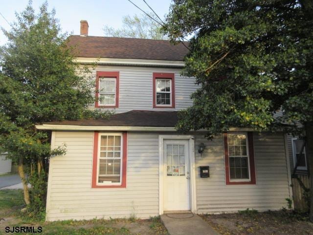 view of front of home featuring a chimney