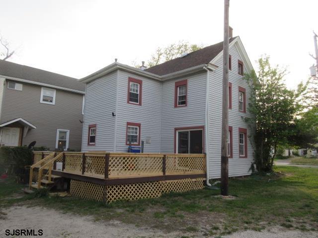 back of house featuring a deck