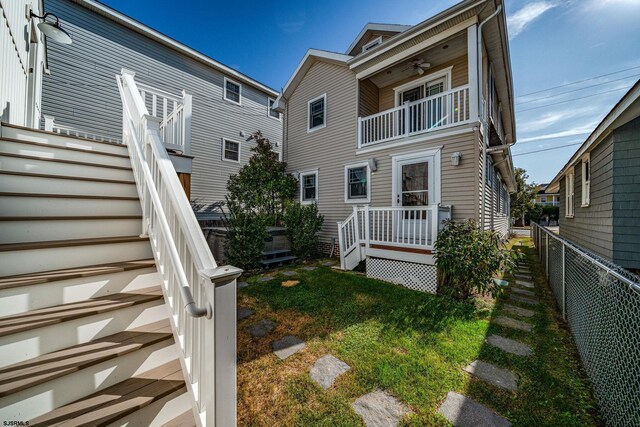 226 Asbury Ave, Ocean City, NJ 08226 - back of property with a fenced backyard, ceiling fan, a yard, and a balcony