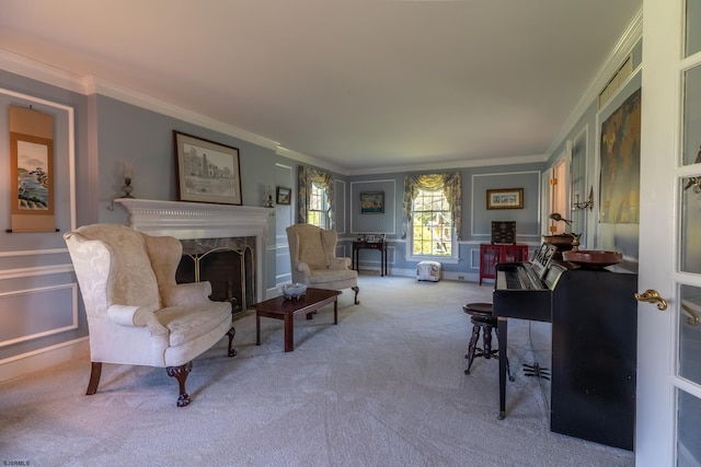 carpeted living room with crown molding, a fireplace, and a decorative wall