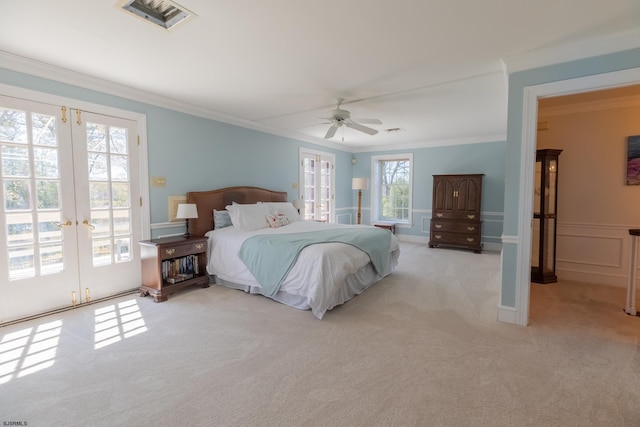 carpeted bedroom featuring access to exterior, french doors, a ceiling fan, visible vents, and ornamental molding