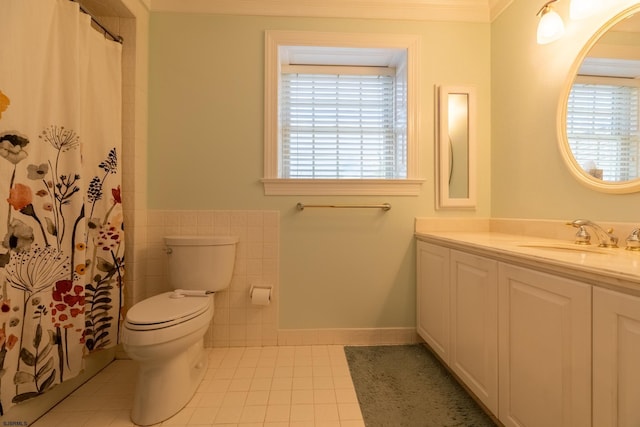 full bath with tile patterned floors, a healthy amount of sunlight, toilet, and tile walls
