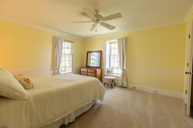 carpeted bedroom featuring crown molding, baseboards, multiple windows, and ceiling fan