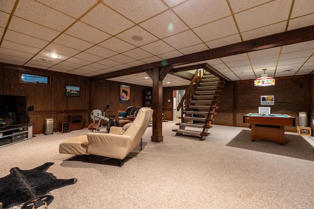 carpeted living room featuring billiards, stairway, wooden walls, a drop ceiling, and recessed lighting