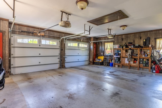 garage with wooden walls and a garage door opener