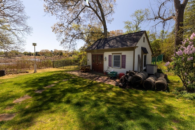 view of outbuilding featuring an outdoor structure and fence