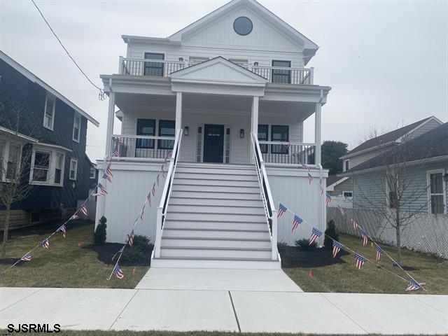 1243 Bay Ave, Ocean City, NJ 08226 - view of front of home featuring a porch, fence, a balcony, and stairway