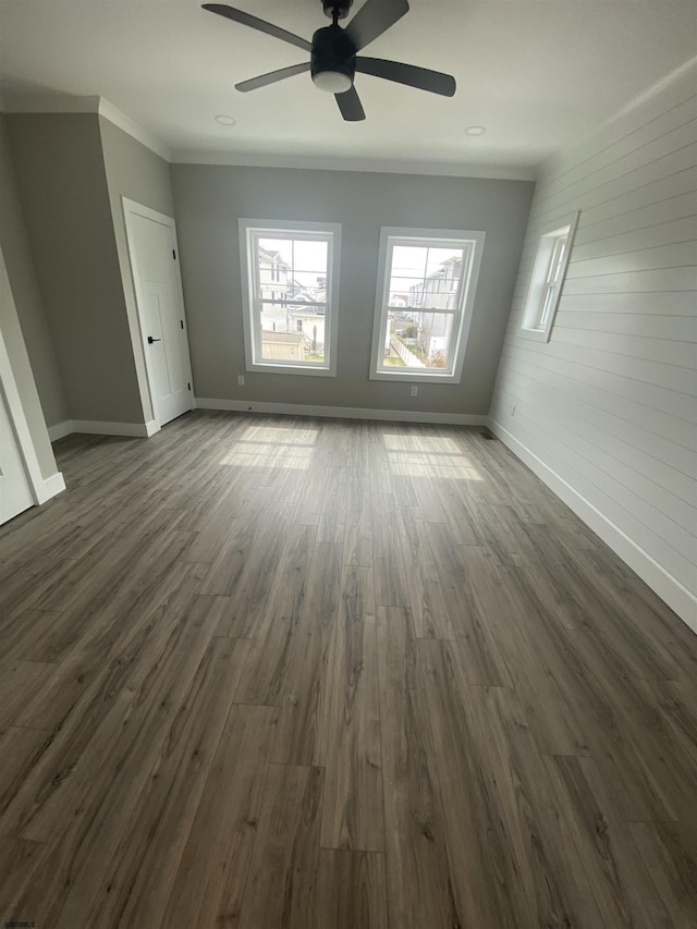 1243 Bay Ave, Ocean City, NJ 08226 - empty room featuring wooden walls, dark wood finished floors, a ceiling fan, baseboards, and ornamental molding