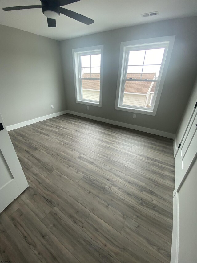 1243 Bay Ave, Ocean City, NJ 08226 - spare room with baseboards, ceiling fan, dark wood-style floors, and visible vents