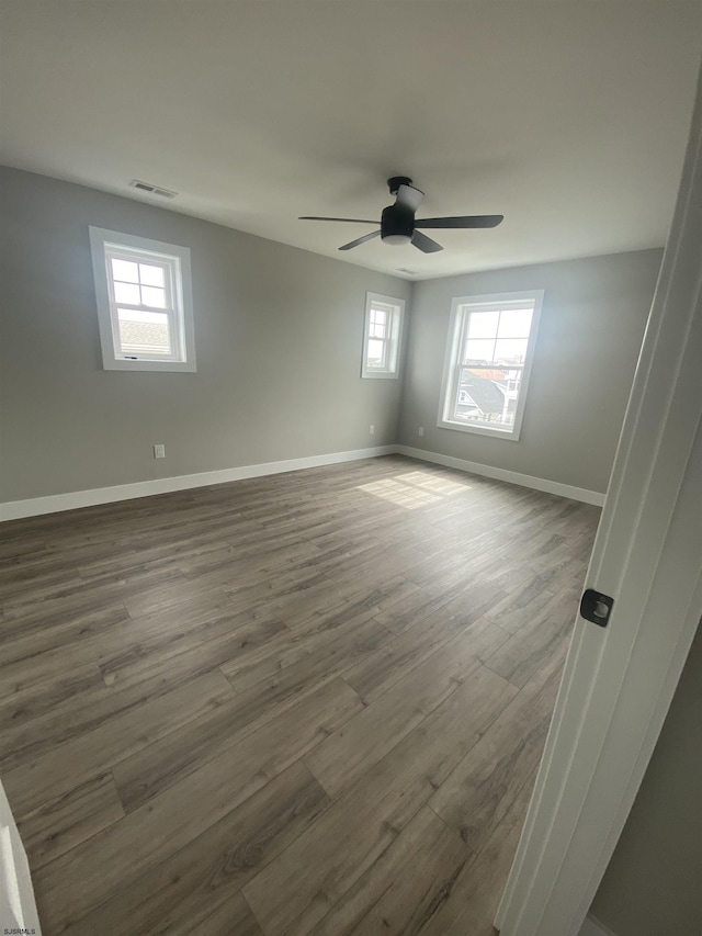 1243 Bay Ave, Ocean City, NJ 08226 - spare room with dark wood-style floors, a ceiling fan, visible vents, and plenty of natural light