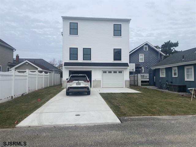 1243 Bay Ave, Ocean City, NJ 08226 - raised beach house with a garage, fence, driveway, and a front yard