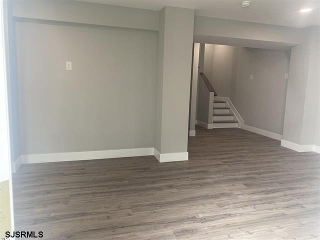 1243 Bay Ave, Ocean City, NJ 08226 - basement featuring baseboards, stairs, and wood finished floors