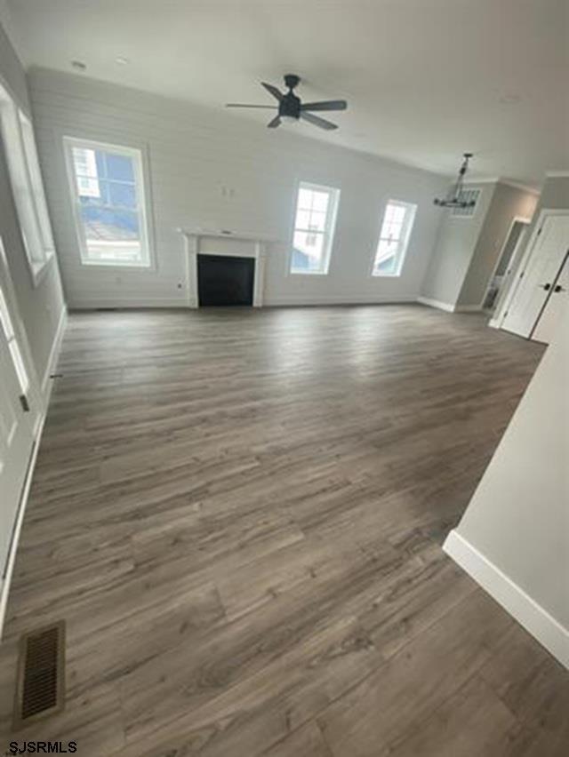 1243 Bay Ave, Ocean City, NJ 08226 - unfurnished living room with baseboards, ceiling fan, wood finished floors, and visible vents